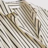 Camisa holgada con botones y dobladillo curvo