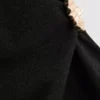Camiseta ajustada con cuello en V y detalles metálicos
