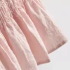 Camiseta sin mangas con bajo peplum fruncido