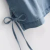 Camiseta sin mangas de denim de algodón con lazos laterales
