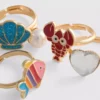 Paquete de 5 anillos con dijes marinos