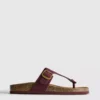 Sandalias tipo mule con barra en T y hebilla